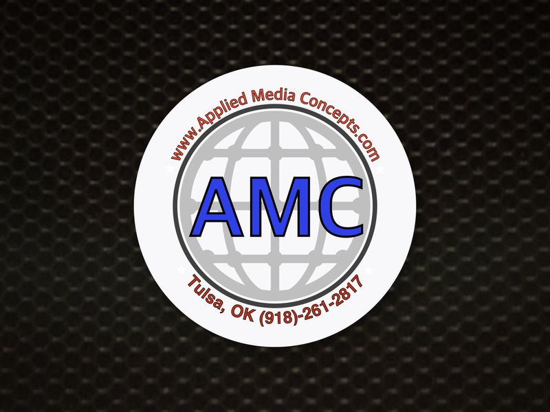 Applied Media Concepts logo on a speaker grille